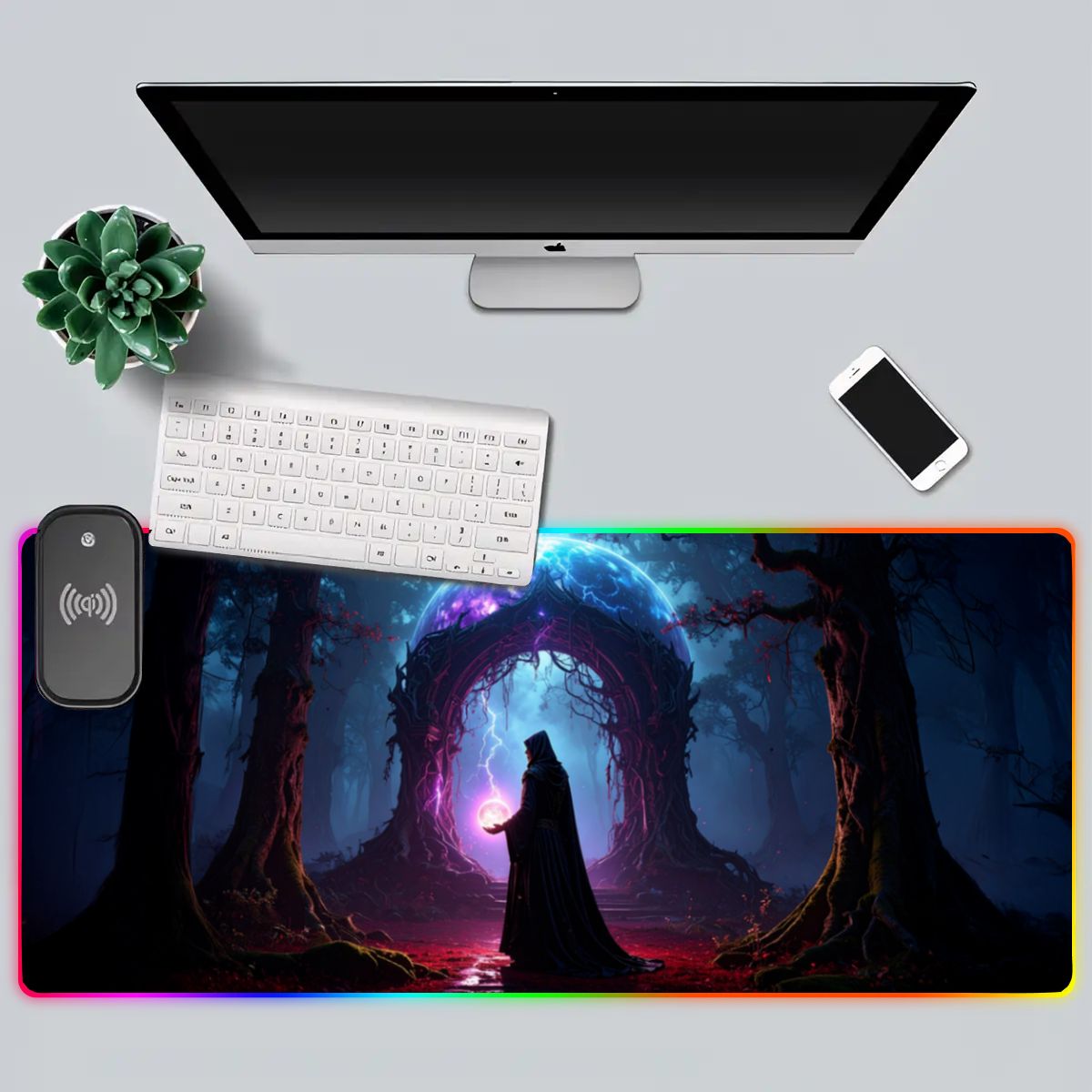 Desk setup with a computer monitor, keyboard, phone, and mouse pad featuring fantasy design.